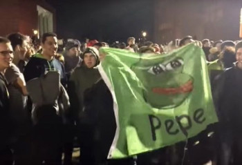 Activists holding Pepe the frog banner.